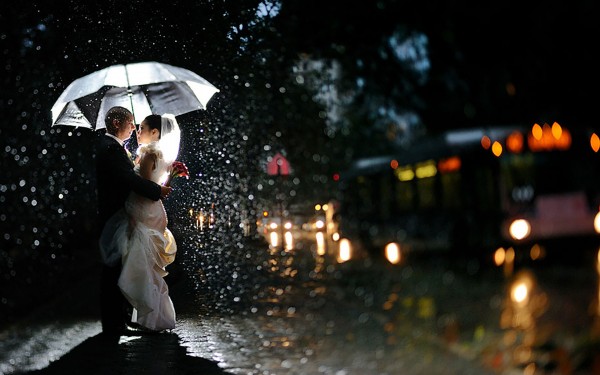 First hug of couple in rain after getting married