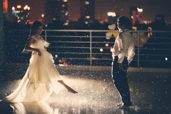 Married couple making fun in a rainy night