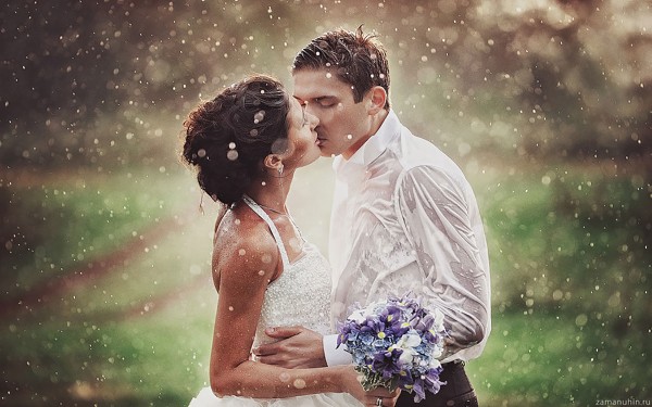 Passionate kiss of married couple in rain