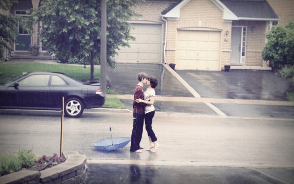 Romantic couple kissing in rain