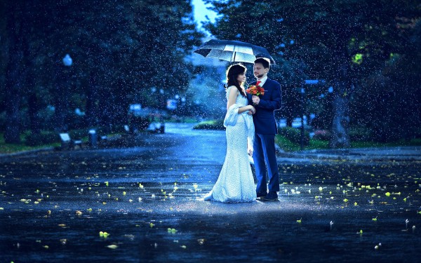 Sweet Couple giving flower in a rainy Morning